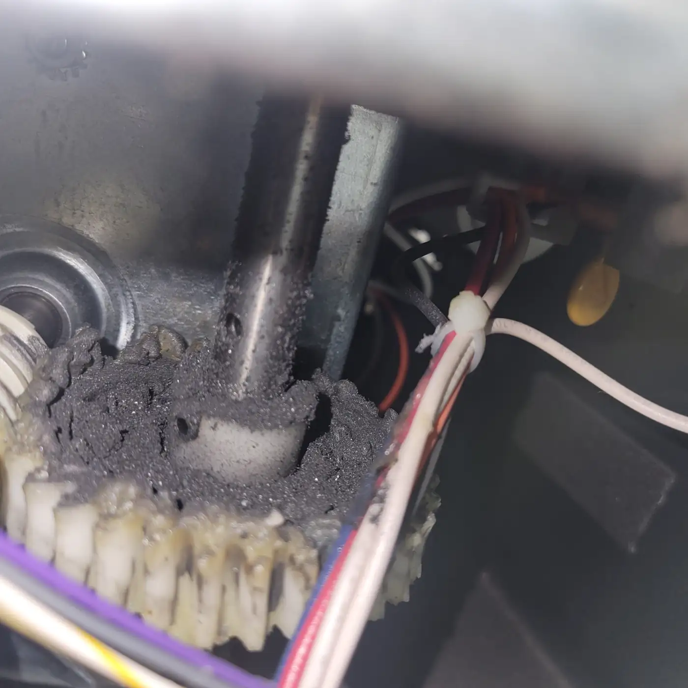 Worn opener drive gear packed with shredded nylon